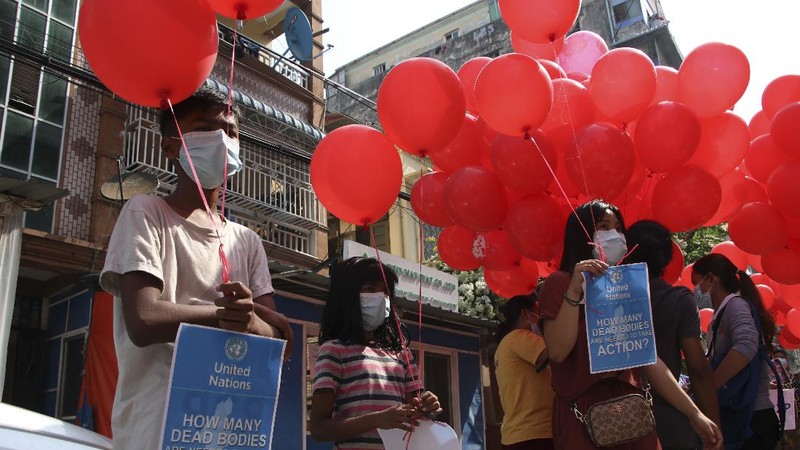 Anti-coup protesters hold red balloon, calling for foreign intervention to aid them in downtown Yangon, Myanmar, Monday, March 22, 2021. Protests against the coup continued in cities and town across the country, including Mandalay and Yangon. (AP Photo)