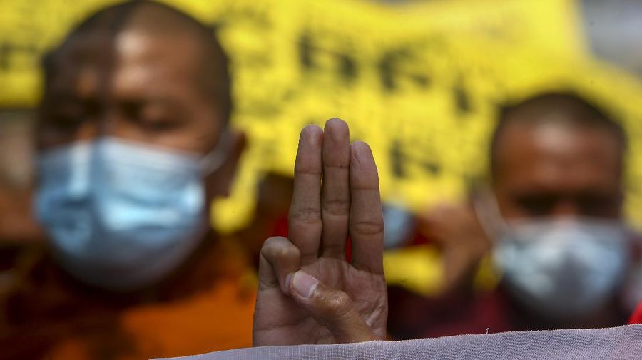Buddhist monks flashing with three-fingered sign of defiance lead a protest march supporting the Committee Representing Pyidaungsu Hluttaw, comprising elected members of Parliament who were not allowed to take their seats after the Feb. 2021 military coup, in Mandalay, Myanmar, Wednesday, March 17, 2021. Demonstrators against last month's military takeover in Myanmar carried on protesting Wednesday despite no letup in the security forces' deadly crackdown against them. (AP Photo)