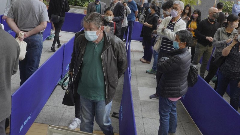 People queue up outside a vaccination center for BioNTech in Hong Kong Wednesday, March 24, 2021. Hong Kong suspended vaccinations using Pfizer shots - known as BioNTech shots in the city - on Wednesday after they were informed by its distributor Fosun that one batch had defective bottle lids. (AP Photo/Vincent Yu)