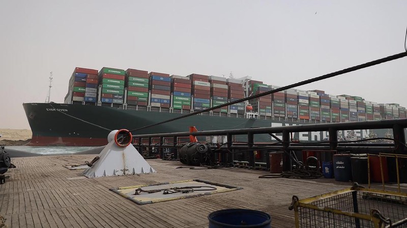 This photo released by the Suez Canal Authority on Thursday, March 25, 2021, shows the Ever Given, a Panama-flagged cargo ship, after it become wedged across the Suez Canal and blocking traffic in the vital waterway. An operation is underway to try to work free the ship wedged across Egypt's Suez Canal, which further imperiled global shipping Thursday as at least 150 other vessels needing to pass through the crucial waterway idled waiting for the obstruction to clear. (Suez Canal Authority via AP)