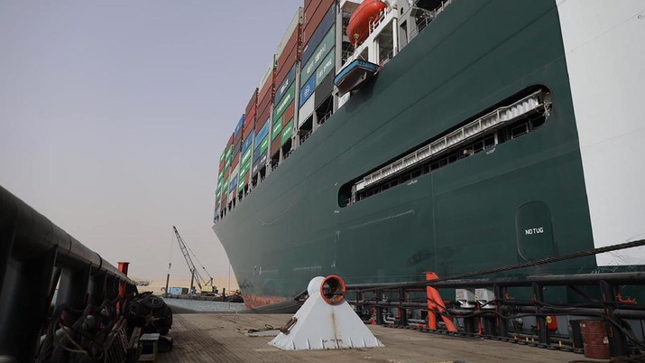 This photo released by the Suez Canal Authority on Thursday, March 25, 2021, shows the Ever Given, a Panama-flagged cargo ship, after it become wedged across the Suez Canal and blocking traffic in the vital waterway, seen from another vessel. An operation is underway to try to work free the ship, which further imperiled global shipping Thursday as at least 150 other vessels needing to pass through the crucial waterway idled waiting for the obstruction to clear. (Suez Canal Authority via AP)
