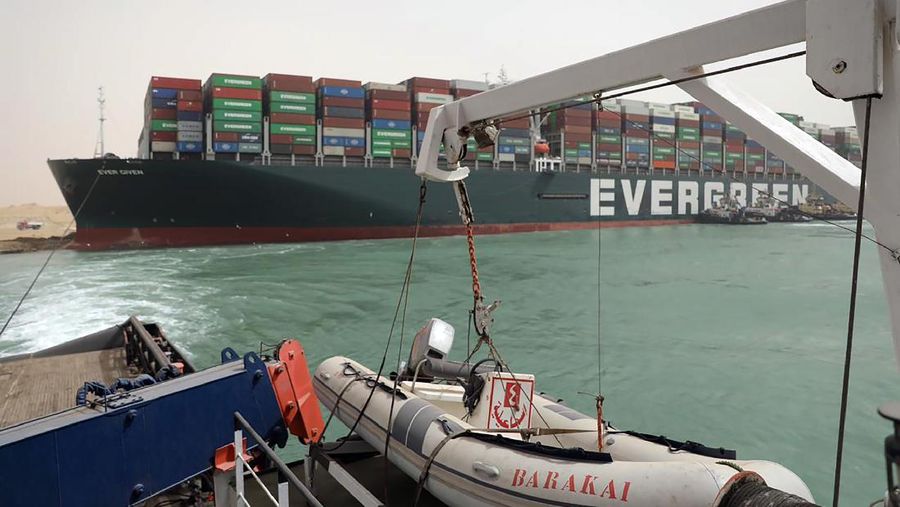 This photo released by the Suez Canal Authority on Thursday, March 25, 2021, shows the Ever Given, a Panama-flagged cargo ship, after it become wedged across the Suez Canal and blocking traffic in the vital waterway. An operation is underway to try to work free the ship wedged across Egypt's Suez Canal, which further imperiled global shipping Thursday as at least 150 other vessels needing to pass through the crucial waterway idled waiting for the obstruction to clear. (Suez Canal Authority via AP)