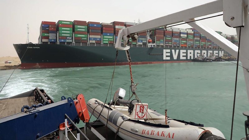 This photo released by the Suez Canal Authority on Thursday, March 25, 2021, shows the Ever Given, a Panama-flagged cargo ship, after it become wedged across the Suez Canal and blocking traffic in the vital waterway. An operation is underway to try to work free the ship wedged across Egypt's Suez Canal, which further imperiled global shipping Thursday as at least 150 other vessels needing to pass through the crucial waterway idled waiting for the obstruction to clear. (Suez Canal Authority via AP)