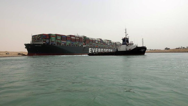 This photo released by the Suez Canal Authority on Thursday, March 25, 2021, shows the Ever Given, a Panama-flagged cargo ship, after it become wedged across the Suez Canal and blocking traffic in the vital waterway. An operation is underway to try to work free the ship wedged across Egypt's Suez Canal, which further imperiled global shipping Thursday as at least 150 other vessels needing to pass through the crucial waterway idled waiting for the obstruction to clear. (Suez Canal Authority via AP)