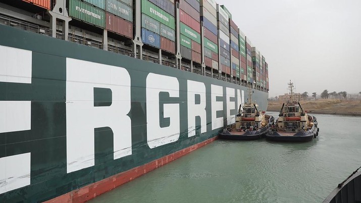 Egypt Suez Canal This photo released by the Suez Canal Authority on Thursday, March 25, 2021, shows two tugboats next to the Ever Given, a Panama-flagged cargo ship, after it become wedged across the Suez Canal and blocking traffic in the vital waterway from another vessel. An operation is underway to try to work free the ship, which further imperiled global shipping Thursday as at least 150 other vessels needing to pass through the crucial waterway idled waiting for the obstruction to clear. (Suez Canal Authority via AP)