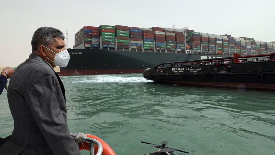 This photo released by the Suez Canal Authority on Thursday, March 25, 2021, shows Lt. Gen. Ossama Rabei, head of the Suez Canal Authority, investigating the situation with  the Ever Given, a Panama-flagged cargo ship, after it become wedged across the Suez Canal and blocking traffic in the vital waterway. An operation is underway to try to work free the ship, which further imperiled global shipping Thursday as at least 150 other vessels needing to pass through the crucial waterway idled waiting for the obstruction to clear. (Suez Canal Authority via AP)