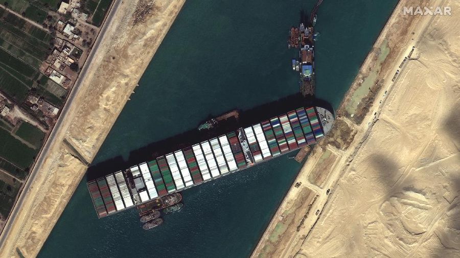 This satellite image from Maxar Technologies shows the cargo ship MV Ever Given stuck in the Suez Canal near Suez, Egypt, Saturday, March 27, 2021.   Authorities are preparing to make new attempts to free the giant container vessel stuck in Egypt's Suez Canal for a fifth day and reopen a crucial east-west waterway for global shipping.   (©Maxar Technologies via AP)