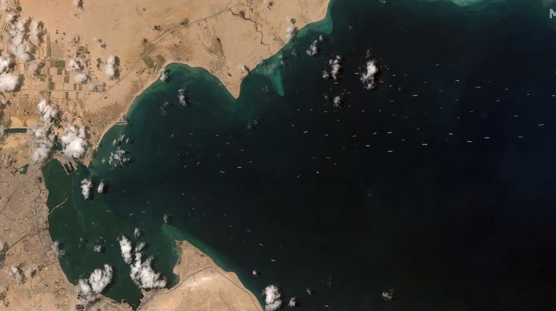 This satellite image from Maxar Technologies shows the cargo ship MV Ever Given stuck in the Suez Canal near Suez, Egypt, Friday, March 26, 2021. A maritime traffic jam grew to more than 200 vessels Friday outside the Suez Canal and some vessels began changing course as dredgers worked frantically to free a giant container ship that is stuck sideways in the waterway and disrupting global shipping. (©Maxar Technologies via AP)