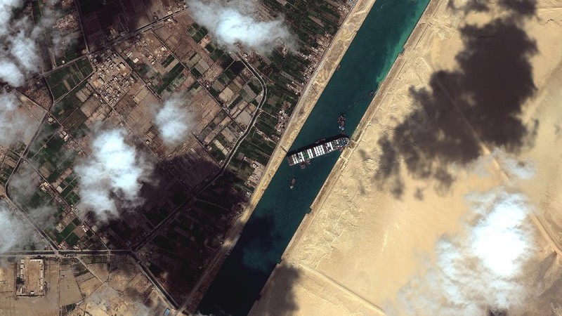 This satellite image from Maxar Technologies shows the cargo ship MV Ever Given stuck in the Suez Canal near Suez, Egypt, Friday, March 26, 2021. A maritime traffic jam grew to more than 200 vessels Friday outside the Suez Canal and some vessels began changing course as dredgers worked frantically to free a giant container ship that is stuck sideways in the waterway and disrupting global shipping. (©Maxar Technologies via AP)