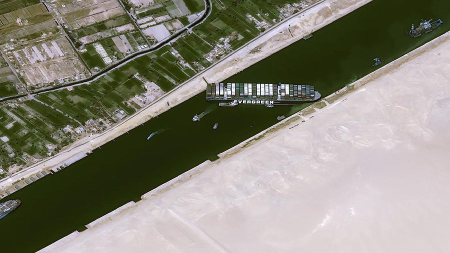 This satellite image from Maxar Technologies shows the cargo ship MV Ever Given stuck in the Suez Canal near Suez, Egypt, Friday, March 26, 2021. A maritime traffic jam grew to more than 200 vessels Friday outside the Suez Canal and some vessels began changing course as dredgers worked frantically to free a giant container ship that is stuck sideways in the waterway and disrupting global shipping. (©Maxar Technologies via AP)