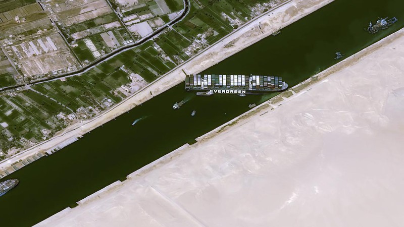 This satellite image from Maxar Technologies shows the cargo ship MV Ever Given stuck in the Suez Canal near Suez, Egypt, Friday, March 26, 2021. A maritime traffic jam grew to more than 200 vessels Friday outside the Suez Canal and some vessels began changing course as dredgers worked frantically to free a giant container ship that is stuck sideways in the waterway and disrupting global shipping. (©Maxar Technologies via AP)