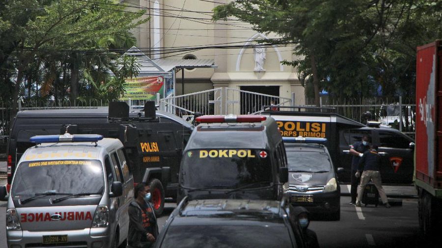 A police officer stands guard near a church where an explosion went off in Makassar, South Sulawesi, Indonesia, Sunday, March 28, 2021. Police in Indonesia say at least one suicide bomber has detonated outside a packed Roman Catholic cathedral during Sunday Mass, wounding several people. (AP Photo/Daeng Mansur)