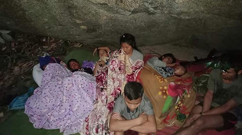 In this photo provided by Free Burma Rangers, villagers shelter in the open due to airstrikes, Saturday, March 27, 2021, in Deh Bu Noh, in Karen state, Myanmar. Myanmar military jets hit a village in Karen State, on Saturday night, killing a few people and wounding others, according to relief organizations.(Free Burma Rangers via AP)
