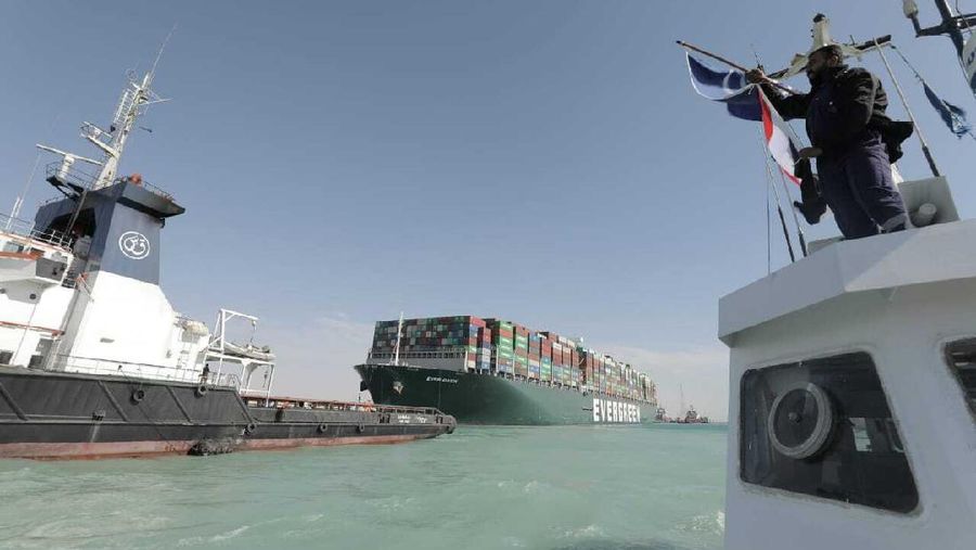 In this photo released by Suez Canal Authority, the Ever Given, a Panama-flagged cargo ship is accompanied by Suez Canal tugboats as it moves in the Suez Canal, Egypt, Monday, March 29, 2021. Salvage teams on Monday set free a colossal container ship that has halted global trade through the Suez Canal, bringing an end to a crisis that for nearly a week had clogged one of the world’s most vital maritime arteries. (Suez Canal Authority via AP)