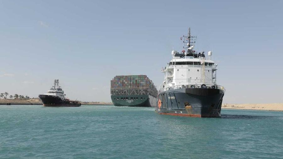 In this photo released by Suez Canal Authority, the Ever Given, a Panama-flagged cargo ship is accompanied by Suez Canal tugboats as it moves in the Suez Canal, Egypt, Monday, March 29, 2021. Salvage teams on Monday set free a colossal container ship that has halted global trade through the Suez Canal, bringing an end to a crisis that for nearly a week had clogged one of the world's most vital maritime arteries. (Suez Canal Authority via AP)