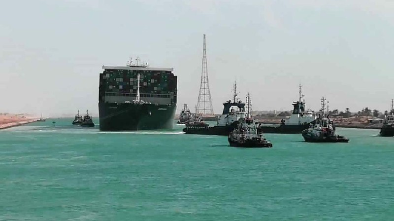 In this photo released by Suez Canal Authority, the Ever Given, a Panama-flagged cargo ship is accompanied by Suez Canal tugboats as it moves in the Suez Canal, Egypt, Monday, March 29, 2021. Salvage teams on Monday set free a colossal container ship that has halted global trade through the Suez Canal, bringing an end to a crisis that for nearly a week had clogged one of the world’s most vital maritime arteries. (Suez Canal Authority via AP)