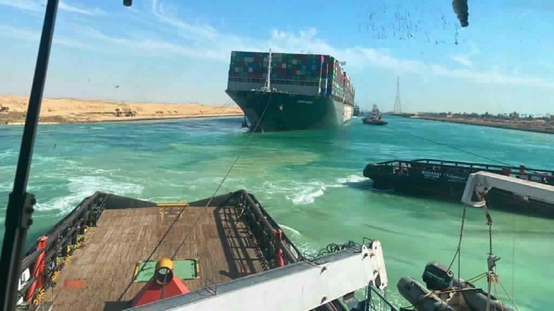 In this photo released by Suez Canal Authority, the Ever Given, a Panama-flagged cargo ship is accompanied by Suez Canal tugboats as it moves in the Suez Canal, Egypt, Monday, March 29, 2021. Salvage teams on Monday set free a colossal container ship that has halted global trade through the Suez Canal, bringing an end to a crisis that for nearly a week had clogged one of the world’s most vital maritime arteries. (Suez Canal Authority via AP)