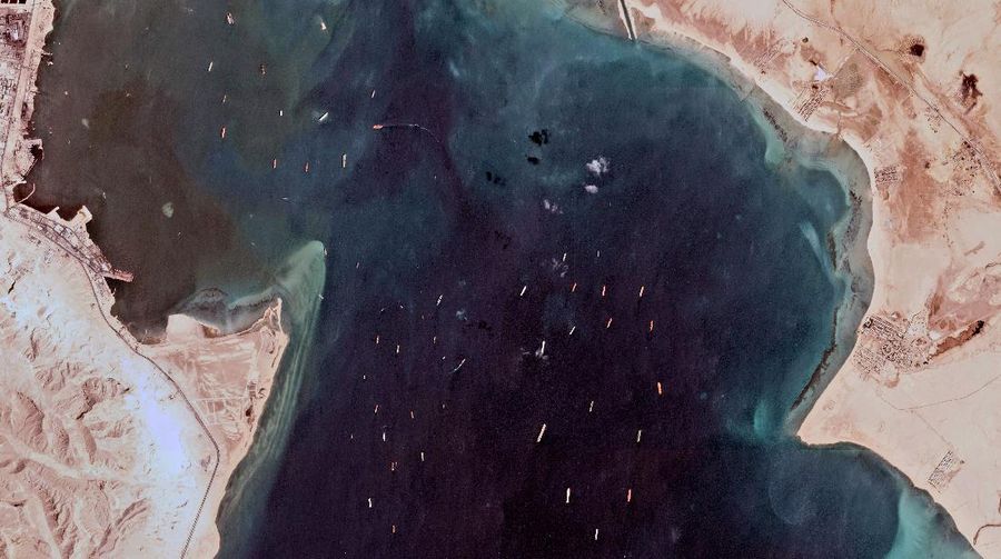 This satellite photo from Planet Labs Inc. shows the Ever Given cargo ship stuck in Egypt's Suez Canal as a mass of ships wait in the Red Sea to pass through the waterway Monday, March 29, 2021. Engineers on Monday 