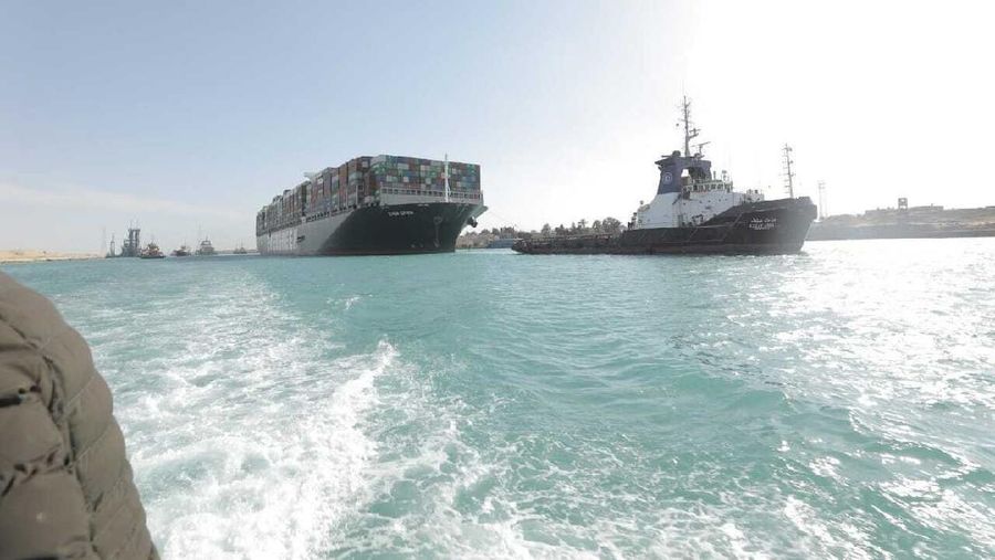 In this photo released by Suez Canal Authority, the Ever Given, a Panama-flagged cargo ship is accompanied by Suez Canal tugboats as it moves in the Suez Canal, Egypt, Monday, March 29, 2021. Salvage teams on Monday set free a colossal container ship that has halted global trade through the Suez Canal, bringing an end to a crisis that for nearly a week had clogged one of the world’s most vital maritime arteries. (Suez Canal Authority via AP)