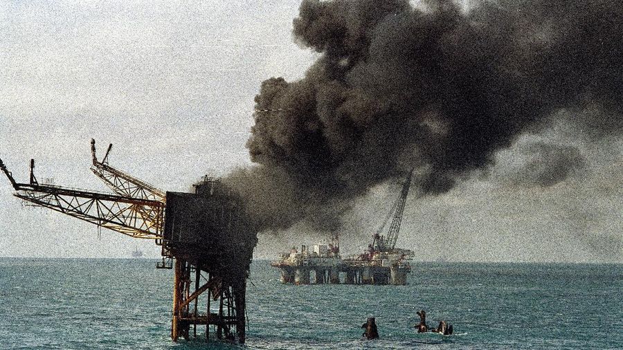 Smoke pours from the remains of the Piper Alpha Oil platform in the North Sea off the coast of Scotland, Friday July 8, 1988. 160 oil rig workers were killed Wednesday night when a massive explosion and fire ripped through the platform. (AP Photo/Dave Cauklin)