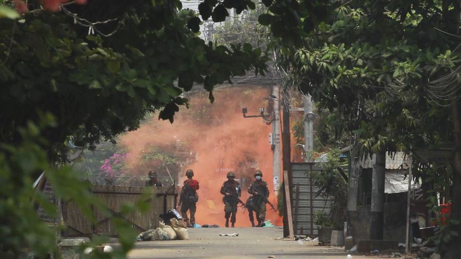 Soldiers walk towards anti-coup protesters during a demonstration in Yangon, Myanmar on Tuesday March 30, 2021. Thailand’s Prime Minister Prayuth Chan-ocha denied Tuesday that his country’s security forces have sent villagers back to Myanmar who fled from military airstrikes and said his government is ready to shelter anyone who is escaping fighting. (AP Photo)