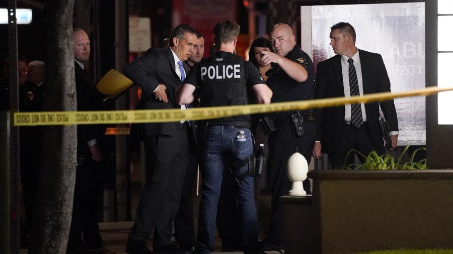 Unidentified people comfort each other as they stand near a business building where a shooting occurred in Orange, Calif., Wednesday, March 31, 2021. Police say several people were killed, including a child, and the suspected shooter was wounded by police. (AP Photo/Jae C. Hong)