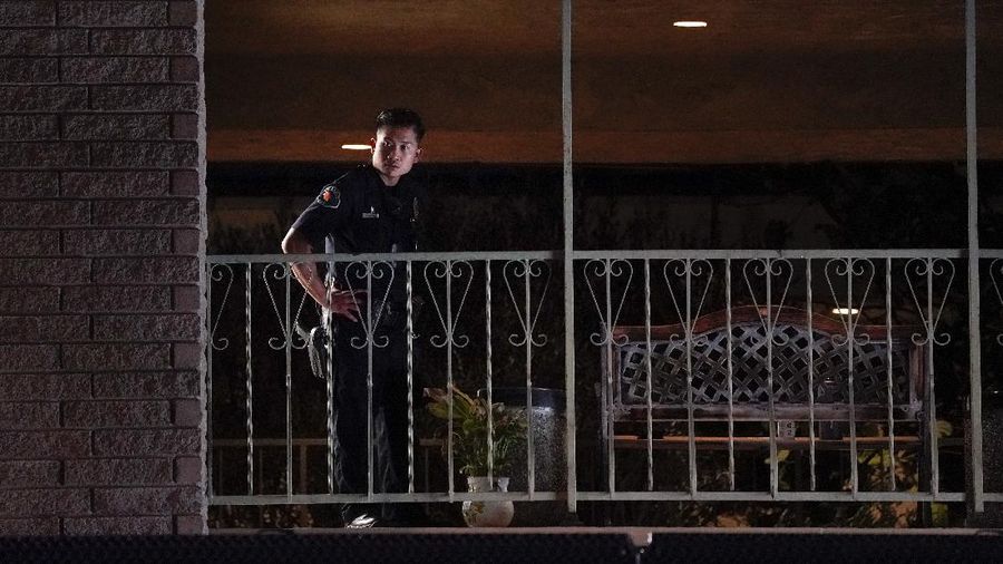 Unidentified people comfort each other as they stand near a business building where a shooting occurred in Orange, Calif., Wednesday, March 31, 2021. Police say several people were killed, including a child, and the suspected shooter was wounded by police. (AP Photo/Jae C. Hong)