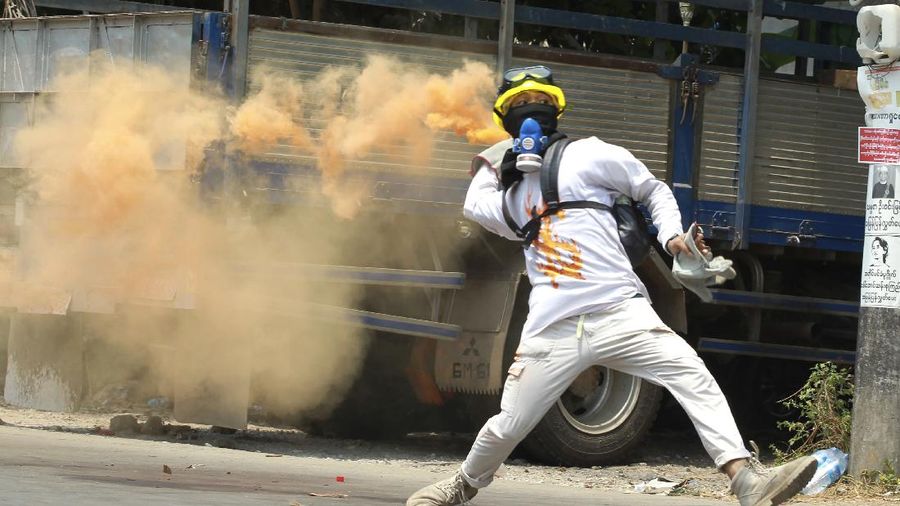 Anti-coup protesters run to avoid military forces during a demonstration in Yangon, Myanmar, Wednesday March 31, 2021. The Southeast Asian nation has been wracked by violence since the military ousted a civilian-led government on Feb. 1 and began to forcibly put down protests. (AP Photo)