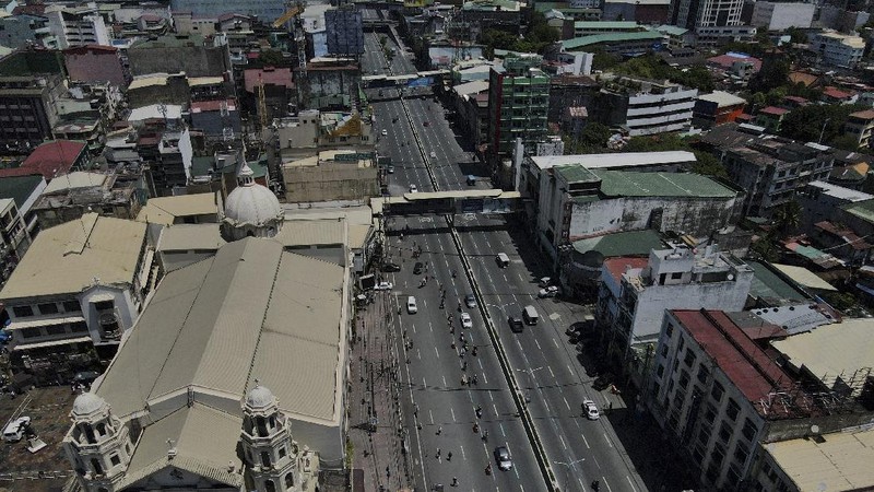 An almost empty Welcome Rotonda roundabout is seen as the government implements a strict lockdown to prevent the spread of the coronavirus on Good Friday, April 2, 2021 in Manila, Philippines. Filipinos marked Jesus Christ's crucifixion Friday in one of the most solemn holidays in Asia's largest Catholic nation which combined with a weeklong coronavirus lockdown to empty Manila's streets of crowds and heavy traffic jams. Major highways and roads were eerily quiet on Good Friday and churches were deserted too after religious gatherings were prohibited in metropolitan Manila and four outlying provinces. (AP Photo/Aaron Favila)