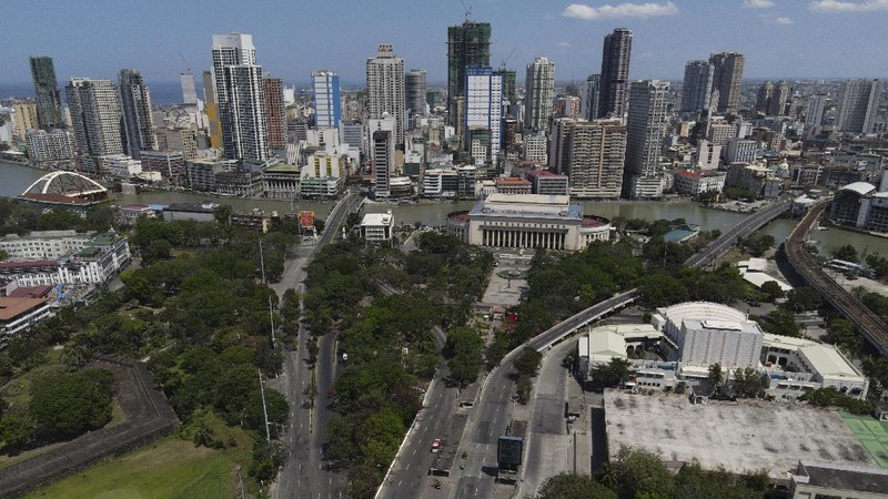 An almost empty Welcome Rotonda roundabout is seen as the government implements a strict lockdown to prevent the spread of the coronavirus on Good Friday, April 2, 2021 in Manila, Philippines. Filipinos marked Jesus Christ's crucifixion Friday in one of the most solemn holidays in Asia's largest Catholic nation which combined with a weeklong coronavirus lockdown to empty Manila's streets of crowds and heavy traffic jams. Major highways and roads were eerily quiet on Good Friday and churches were deserted too after religious gatherings were prohibited in metropolitan Manila and four outlying provinces. (AP Photo/Aaron Favila)