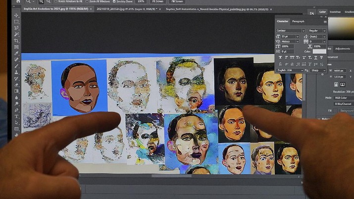 David Hanson, left, creator of Sophia, shows a work of Sophia at his studio in Hong Kong on March 29, 2021. Sophia is a robot of many talents — she speaks, jokes, sings and even makes art. In March, she caused a stir in the art world when a digital work she created as part of a collaboration was sold at an auction for $688,888 in the form of a non-fungible token (NFT).WLD(AP Photo/Vincent Yu)