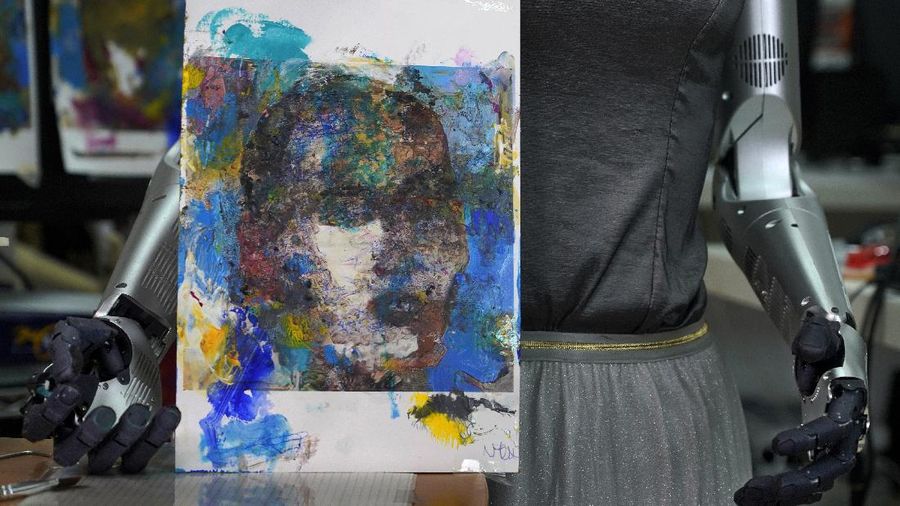 David Hanson, left, creator of Sophia, shows a work of Sophia at his studio in Hong Kong on March 29, 2021. Sophia is a robot of many talents — she speaks, jokes, sings and even makes art. In March, she caused a stir in the art world when a digital work she created as part of a collaboration was sold at an auction for $688,888 in the form of a non-fungible token (NFT).WLD(AP Photo/Vincent Yu)