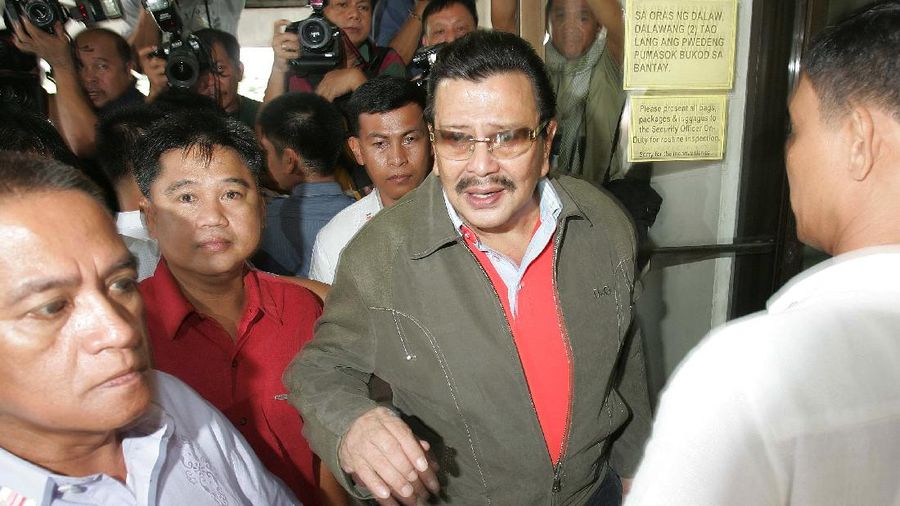 Ousted Philippine President Joseph Estrada walks with tight security as he visits his sick mother Mary Ejercito at the hospital in suburban San Juan, east of Manila on Sunday Sept. 9, 2007. The Philippine anti-graft court will issue a verdict next week in the 6-year-old plunder trial of ousted President Joseph Estrada, an official said Friday, as security forces braced for possible unrest by his supporters. (AP Photo/Aaron Favila)