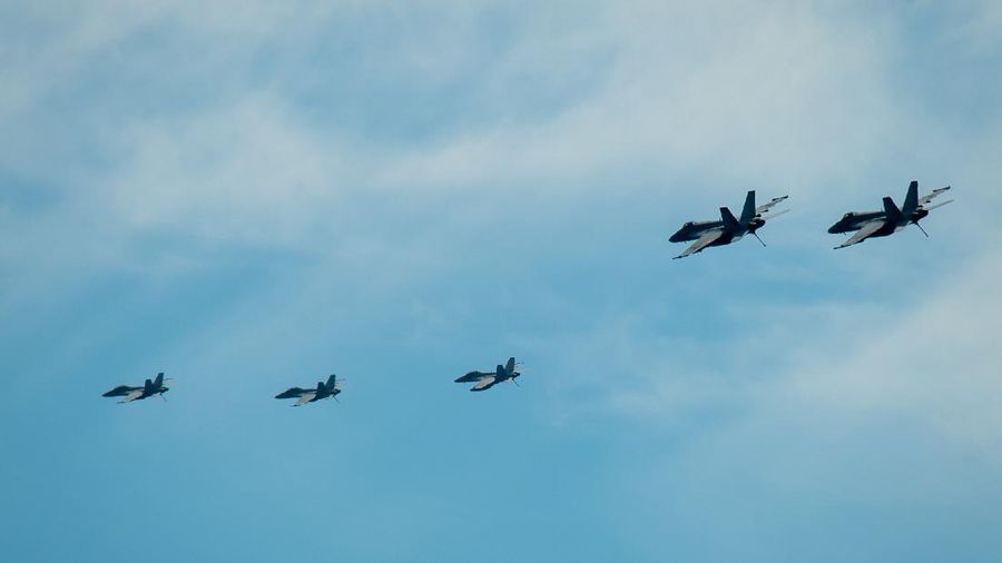 SOUTH CHINA SEA (April 6, 2021) – Aircraft from Carrier Air Wing (CVW) 11 fly above the aircraft carrier USS Theodore Roosevelt (CVN 71) April 6, 2021. The Theodore Roosevelt Carrier Strike Group is on a scheduled deployment to the U.S. 7th Fleet area of operations. As the U.S. Navy’s largest forward-deployed fleet, 7th Fleet routinely operates and interacts with 35 maritime nations while conducting missions to preserve and protect a free and open Indo-Pacific Region. (U.S. Navy photo by Mass Communication 3rd Class Dartañon D. De La Garza)