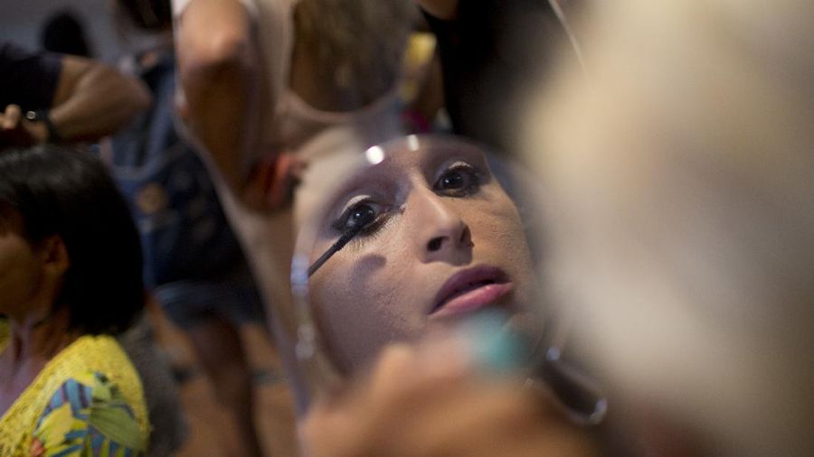 A sex worker reflected in a mirror gets her make-up applied before the the Daspu fashion show, an event during the Women of the World Festival in Rio de Janeiro, Brazil, Sunday, Nov. 18, 2018. Daspu, a wordplay on the expression 