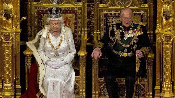 FILE - In this Wednesday, May 9, 2012 file photo, Britain's Queen Elizabeth II sits next to Prince Philip in the House of Lords as she waits to read the Queen's Speech to lawmakers in London. Buckingham Palace says Prince Philip, husband of Queen Elizabeth II, has died aged 99. (AP Photo/Alastair Grant, File)