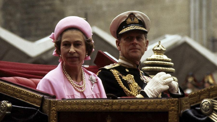 FILE - In this June 7, 1977 file photo, Britain's Queen Elizabeth II and Prince Philip travel in the open landau on the return processional drive to Buckingham Palace, London, after lunch at the Guildhall to celebrate the Silver Jubilee. Prince Philip, the irascible and tough-minded husband of Queen Elizabeth II who spent more than seven decades supporting his wife in a role that both defined and constricted his life, has died, Buckingham Palace said Friday, April 9, 2021. He was 99. (PA via AP, File)