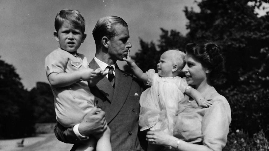 FILE - In this July 31, 1947 file photo, Lieut. Philip Mountbatten, as he was then called, center, inspects his men at the Petty Officers' Training Center at Corsham, England. There certainly won't be fuss. Count on that. When Britain's Prince Philip reaches the grand age of 99 on Wednesday, he will spend it quietly and in much the same way he's spent most of his adult life: beside Queen Elizabeth II. Prince Philip was born into the Greek royal family but spent almost all of his life as a pillar of the British one. His path was forged when he married the heir to the British throne, and a promising naval career was cut short when his wife suddenly became Queen Elizabeth II. Nevertheless, he set about forging a place for himself as royal consort. He was a patron of charities and a supporter of projects for young people. He was married for more than 73 years and was still carrying out royal engagements into his late 90s. (AP Photo/File)