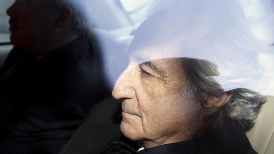 FILE - In this Jan. 5, 2009 file photo, Bernard Madoff, right, leaves U.S. District Court in Manhattan after a bail hearing in New York.  Madoff, the financier who pleaded guilty to orchestrating the largest Ponzi scheme in history, died early Wednesday, April 14, 2021,  in a federal prison, a person familiar with the matter told The Associated Press. (AP Photo/Kathy Willens, File)