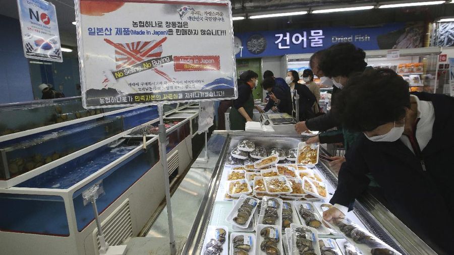 A notice denouncing the Japanese government's decision on releasing treated radioactive Fukushima water hangs at the seafood section of a grocery store in Seoul, South Korea, Friday, April 16, 2021. Japan's government announced Tuesday it would start releasing treated radioactive water from the wrecked Fukushima nuclear plant into the Pacific Ocean in two years. It's a move that's fiercely opposed by fishermen, residents and Japan's neighbors. The signs read: 