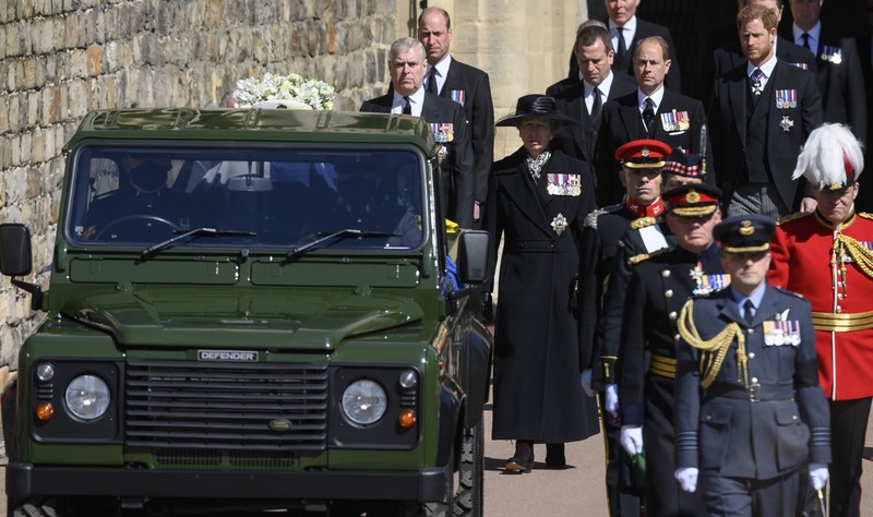 Britain's Princess Anne, from front centre behind coffin, Prince Andrew, Prince Edward, Prince William, Peter Phillips, Prince Harry follow the coffin as it makes it's way past the Round Tower during the funeral of Britain's Prince Philip inside Windsor Castle in Windsor, England Saturday April 17, 2021. (Leon Neal/Pool via AP)