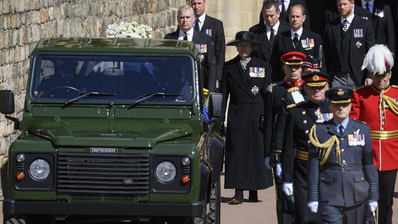 Britain's Princess Anne, from front centre behind coffin, Prince Andrew, Prince Edward, Prince William, Peter Phillips, Prince Harry follow the coffin as it makes it's way past the Round Tower during the funeral of Britain's Prince Philip inside Windsor Castle in Windsor, England Saturday April 17, 2021. (Leon Neal/Pool via AP)