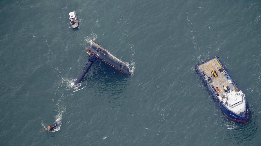 Rescue boats are seen next to the capsized lift boat Seacor Power seven miles off the coast of Louisiana in the Gulf of Mexico Sunday, April 18, 2021. The vessel capsized during a storm on Tuesday. (AP Photo/Gerald Herbert)