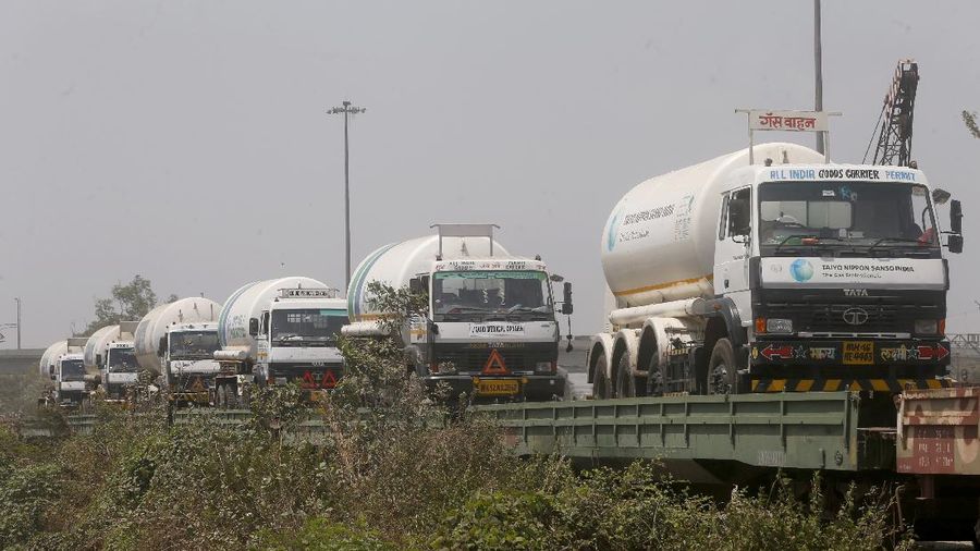Empty tankers are loaded on a train wagon at the Kalamboli goods yard in Navi Mumbai, Maharashtra state, India, before they are transported to collect liquid medical oxygen from other states, Monday, April 19, 2021. The western Maharashtra state, which is worst hit by the coronavirus is facing a shortage of the gas used for the treatment of COVID-19 patients. (AP Photo/Rafiq Maqbool)