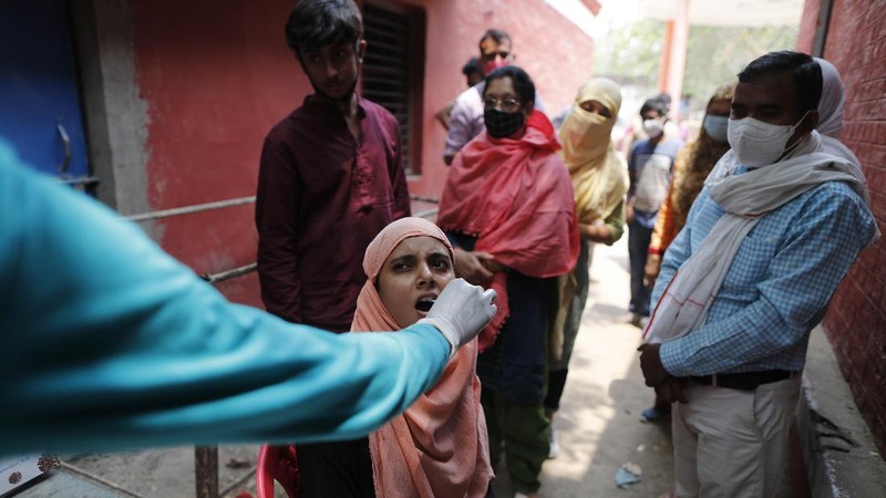 Ambulances carrying COVID-19 patients line up waiting for their turn to be attended at a dedicated COVID-19 government hospital in Ahmedabad, India, Saturday, April 17, 2021. The global death toll from the coronavirus topped a staggering 3 million people Saturday amid repeated setbacks in the worldwide vaccination campaign and a deepening crisis in places such as Brazil, India and France. (AP Photo/Ajit Solanki)