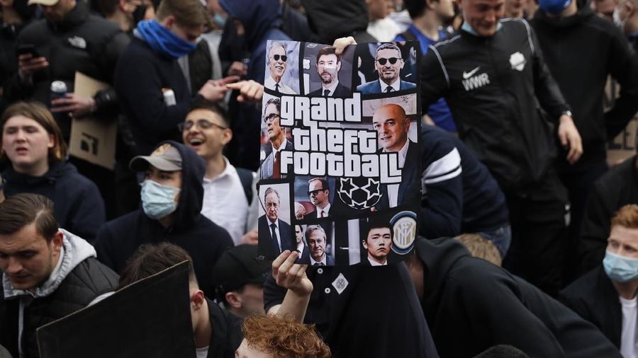Chelsea fans protest outside Stamford Bridge stadium in London, against Chelsea's decision to be included amongst the clubs attempting to form a new European Super League, Tuesday, April 20, 2021. Reaction to the proposals from 12 clubs to rip up European soccer by forming a breakaway Super League has ranged from anger and condemnation to humor and sarcasm. (AP Photo/Matt Dunham)