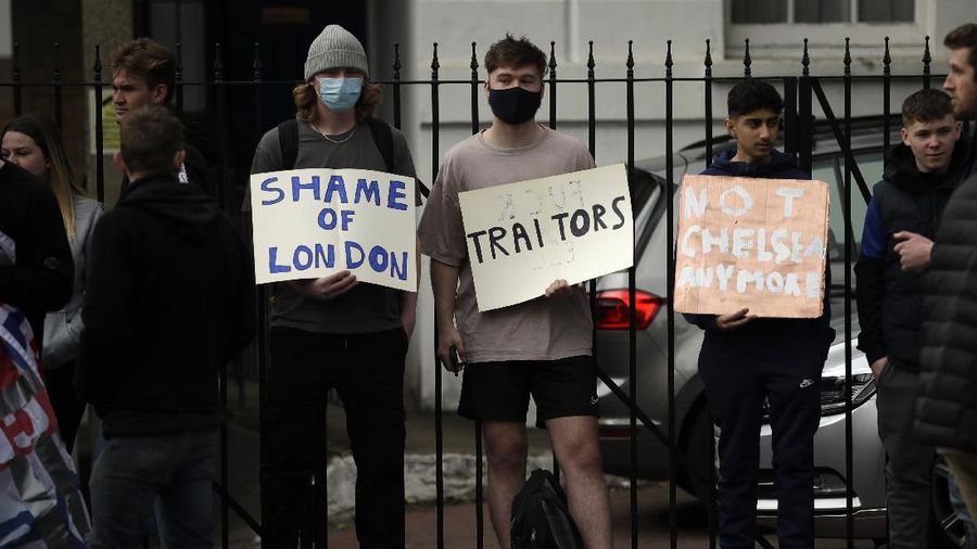 Chelsea fans protest outside Stamford Bridge stadium in London, against Chelsea's decision to be included amongst the clubs attempting to form a new European Super League, Tuesday, April 20, 2021. Reaction to the proposals from 12 clubs to rip up European soccer by forming a breakaway Super League has ranged from anger and condemnation to humor and sarcasm. (AP Photo/Matt Dunham)