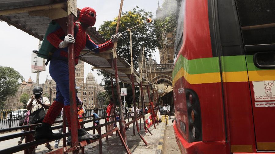 Indian social worker Ashok Kurmi dressed as spider man sanitizes the area around Chhatrapati Shivaji Maharaj train Terminus during a lockdown imposed to curb the spread of COVID-19 in Mumbai, India, Wednesday, April 21, 2021. (AP Photo/Rajanish Kakade)