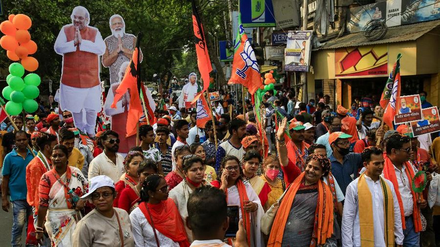 Supporters of India's ruling Bharatiya Janata Party (BJP) participate in an election rally ahead of the third phase of West Bengal state elections in Kolkata, India, Monday, April 5, 2021. India’s election authorities announced voting in five states starting massive campaign rallies and roadshows by Prime Minister Narendra Modi, Home Minister Amit Shah as well as opposition politicians with tens of thousands of supporters with no masks and social distancing. India is being overrun by hundreds of thousands of new coronavirus cases, bringing a new reality for daily life in its main cities and towns. (AP Photo/Bikas Das)