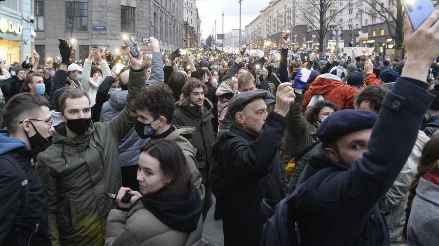 People light their cell phones during a protest in support of jailed opposition leader Alexei Navalny in Moscow, Russia, Wednesday, April 21, 2021. Human rights groups say police across Russia have arrested more than 180 people in connection with demonstrations supporting imprisoned opposition leader Alexei Navalny. Many were seized before protests even began, including two top Navalny associates in Moscow. (AP Photo/Denis Kaminev)